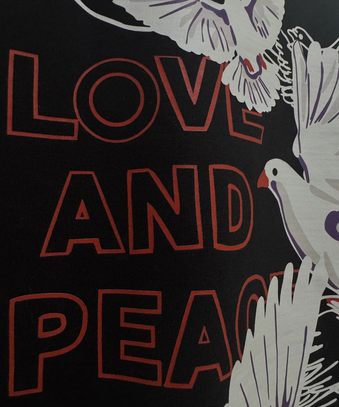 Detailed texture shot of 240 GSM French Terry cotton fabric on the Love and Peace oversized streetwear tee.