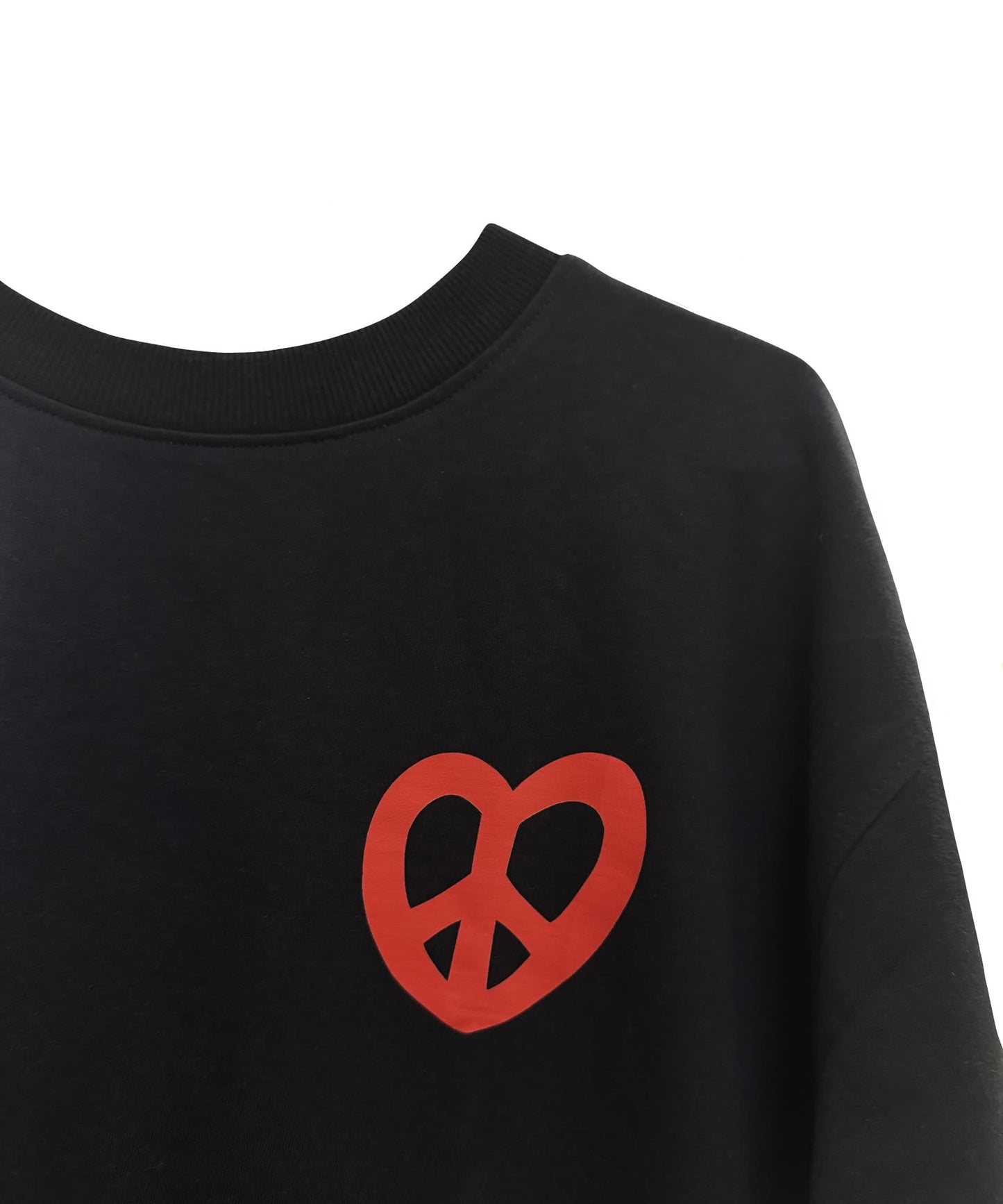 Close-up of the red heart-shaped peace symbol and handwritten message detail – Sense of Street.