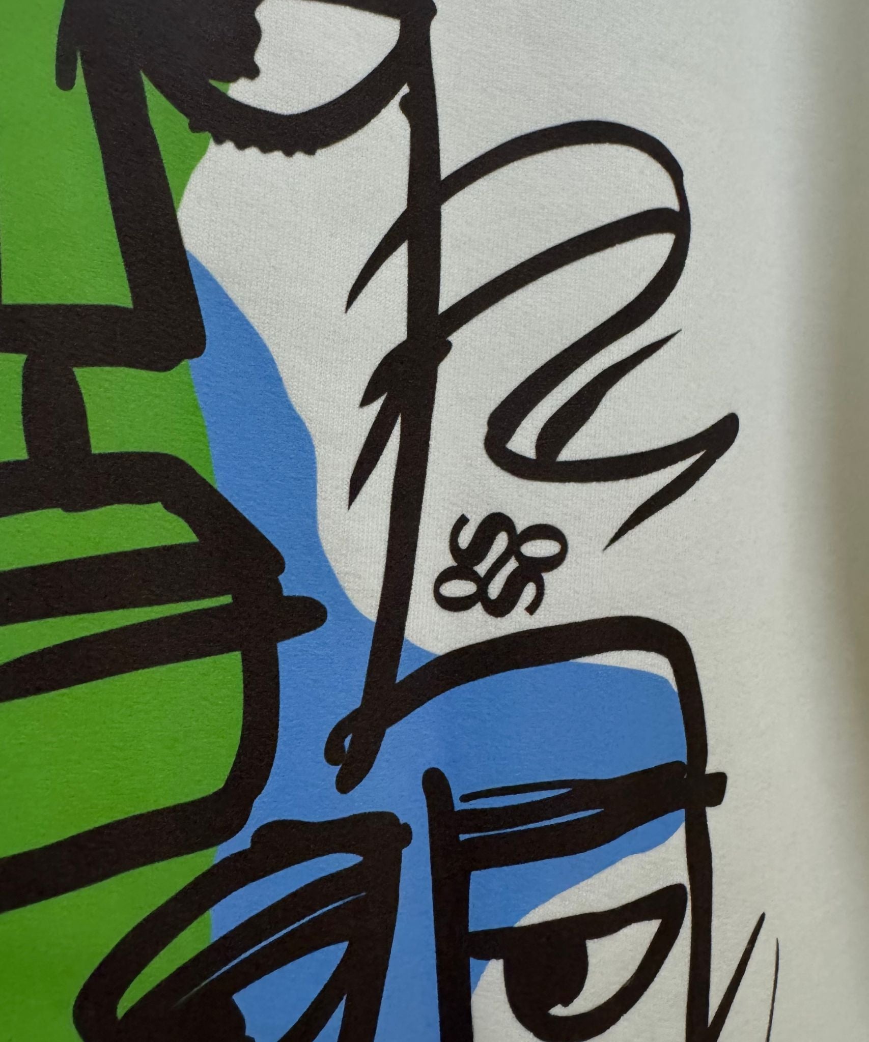 Detailed view of blue and green abstract splashes and graffiti-style line art – Sense of Street original design.