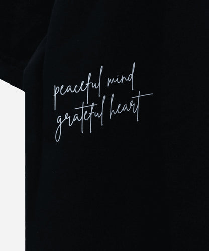 Close-up of the SOS branding emblem integrated into the Love and Peace back graphic - Sense of Street India. Peaceful Mind, Grateful Heart.