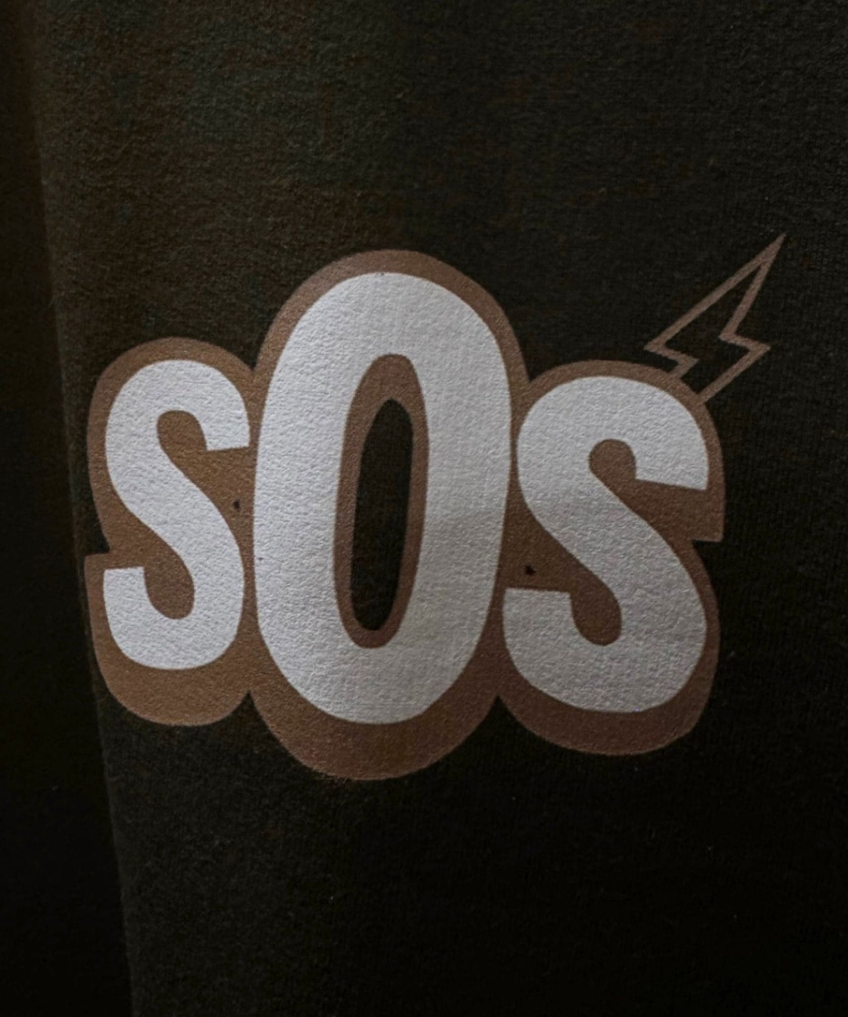 Close-up detail of Money Talks graphic print quality and 240 GSM moss green fabric texture – Sense of Street.